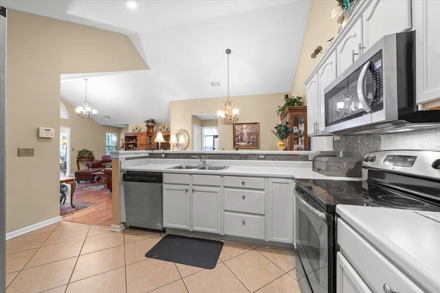 1961 Appling Oaks Cir Unit 29, Cordova, TN 38016 - kitchen with stainless steel appliances, a chandelier, a sink, a peninsula, and light tile patterned flooring