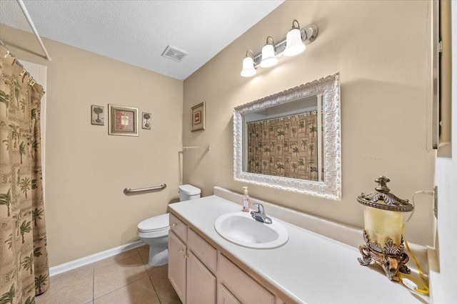 1961 Appling Oaks Cir Unit 29, Cordova, TN 38016 - bathroom with toilet, vanity, tile patterned flooring, a textured ceiling, and baseboards