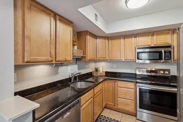 1819 Crossflower Cv Unit 85, Germantown, TN 38138 - kitchen with appliances with stainless steel finishes, a sink, light tile patterned floors, and dark stone countertops