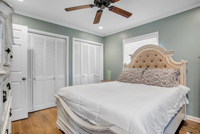 4951 Lynbar Ave, Memphis, TN 38117 - bedroom featuring two closets, crown molding, hardwood / wood-style floors, recessed lighting, and ceiling fan
