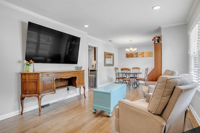 4951 Lynbar Ave, Memphis, TN 38117 - living area featuring light wood-style floors, a chandelier, crown molding, recessed lighting, and baseboards