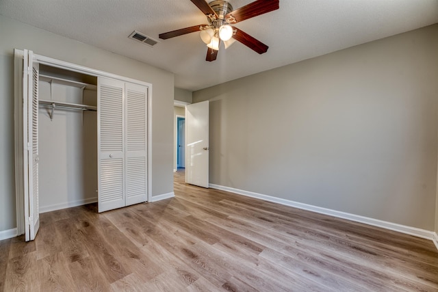 5432 Burton Church Cv Unit 5432, Bartlett, TN 38134 - unfurnished bedroom featuring light wood-style flooring, a closet, baseboards, and a ceiling fan