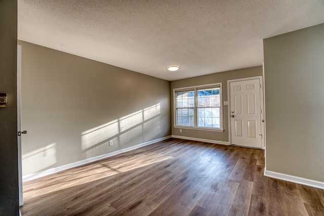 5432 Burton Church Cv Unit 5432, Bartlett, TN 38134 - spare room featuring dark wood-type flooring, baseboards, and a textured ceiling
