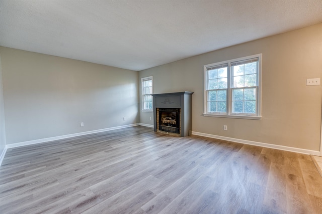 5432 Burton Church Cv Unit 5432, Bartlett, TN 38134 - unfurnished living room with wood finished floors, a fireplace with flush hearth, and baseboards