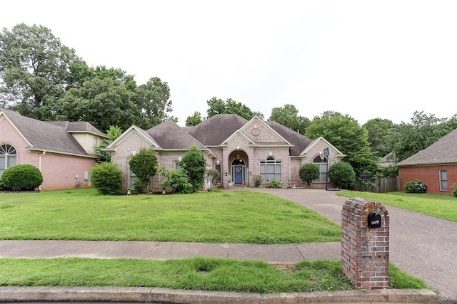 8741 River Hollow Dr, Memphis, TN 38016 - view of front of home featuring brick siding, a front lawn, and asphalt driveway