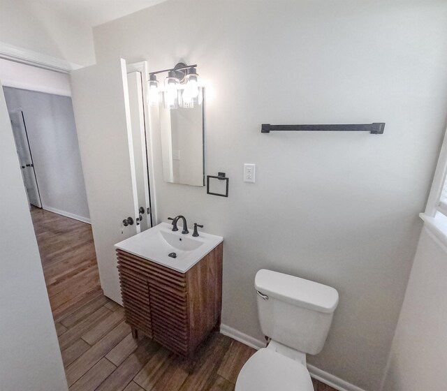 3547 Randolph St, Memphis, TN 38127 - bathroom featuring toilet, vanity, wood finished floors, and baseboards