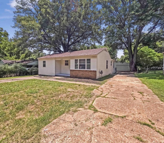 3547 Randolph St, Memphis, TN 38127 - view of front of property with brick siding, concrete driveway, and a front yard