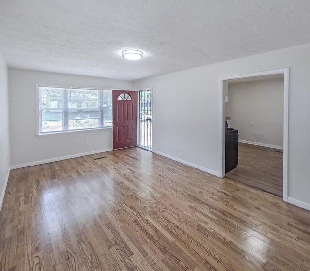 3547 Randolph St, Memphis, TN 38127 - foyer entrance featuring wood finished floors, a textured ceiling, and baseboards