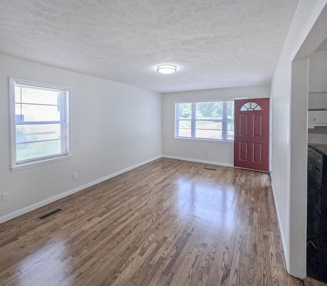 3547 Randolph St, Memphis, TN 38127 - foyer entrance featuring wood finished floors, a textured ceiling, and baseboards