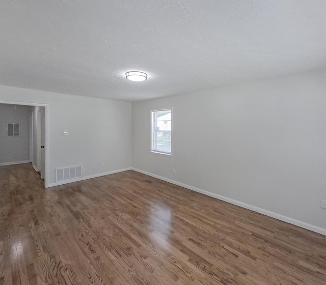 3547 Randolph St, Memphis, TN 38127 - empty room featuring wood finished floors, baseboards, and a textured ceiling