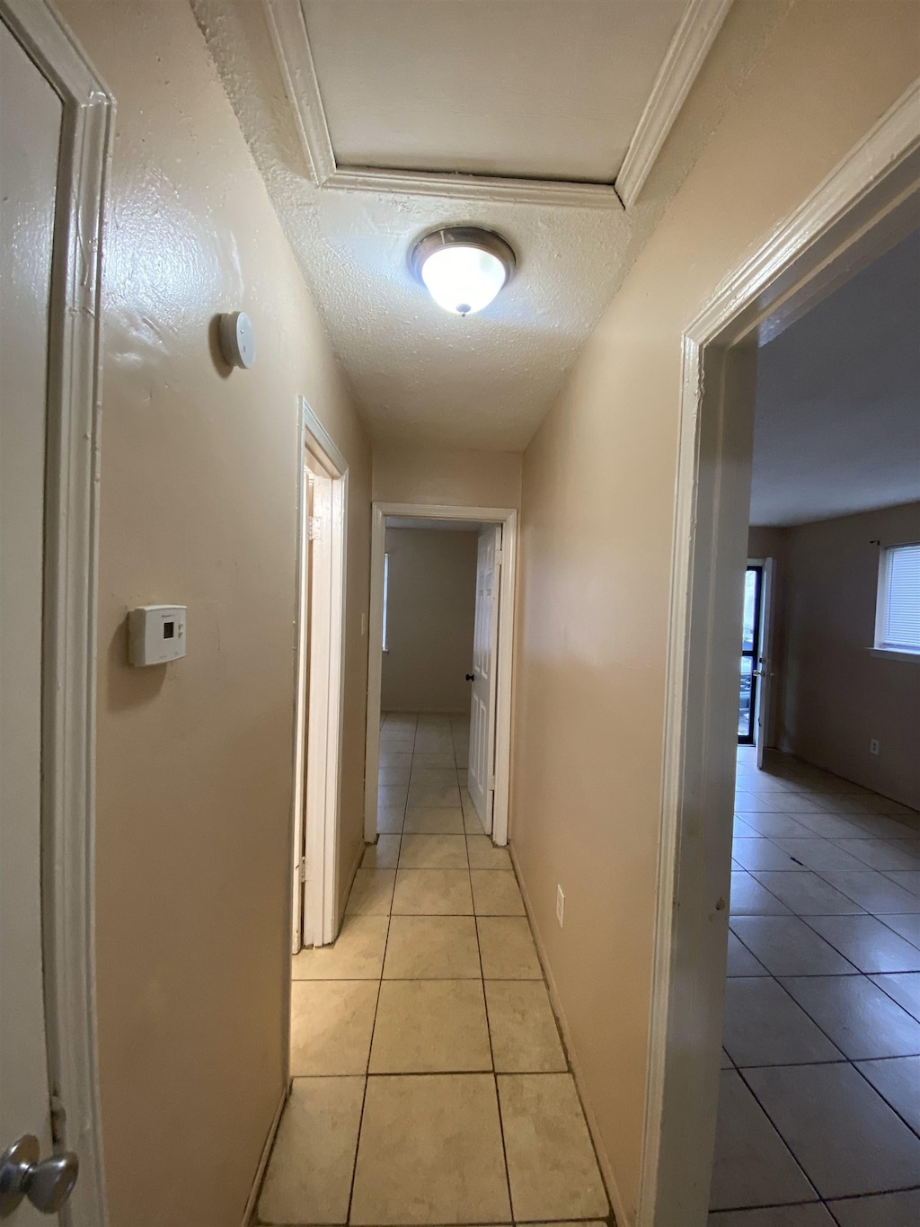 2284 Norman Ave, Memphis, TN 38108 - hall featuring light tile patterned floors and a textured ceiling