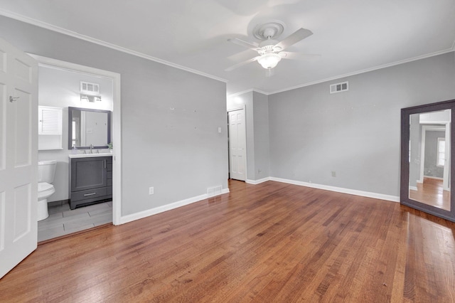 5238 Peg Ln, Memphis, TN 38117 - unfurnished bedroom featuring wood finished floors, crown molding, ensuite bath, and a ceiling fan