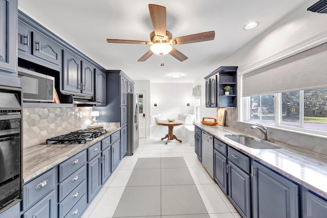 5238 Peg Ln, Memphis, TN 38117 - kitchen with stainless steel appliances, tasteful backsplash, a ceiling fan, and light stone counters