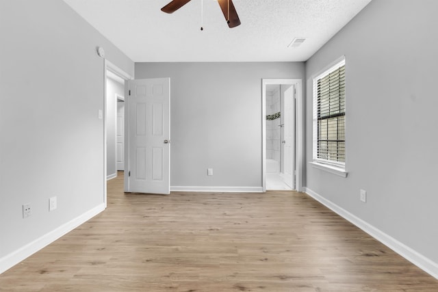 5315 Sleepy Oak Cv, Memphis, TN 38141 - unfurnished bedroom with light wood-type flooring, baseboards, ensuite bath, and a textured ceiling