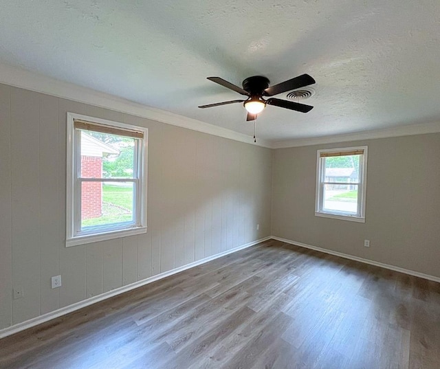 4485 Dunn Rd, Memphis, TN 38117 - unfurnished room featuring wood finished floors, ornamental molding, a ceiling fan, baseboards, and a textured ceiling