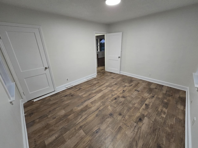4078 Burrow Ave, Memphis, TN 38128 - unfurnished bedroom featuring dark wood-style flooring and baseboards