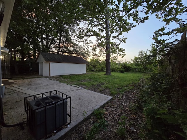 4078 Burrow Ave, Memphis, TN 38128 - view of green lawn with an outdoor structure and a patio area