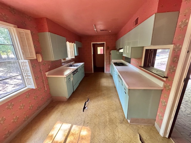 5429 Normandy Rd, Memphis, TN 38120 - kitchen with a sink, light flooring, light countertops, baseboards, and stovetop