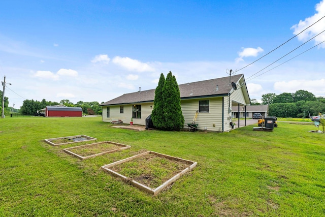 59 Crosswinds Cv, Henning, TN 38041 - rear view of property with a garden, a yard, and roof with shingles