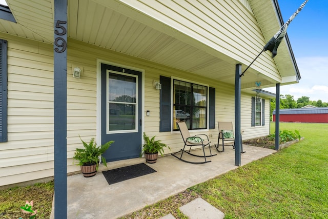 59 Crosswinds Cv, Henning, TN 38041 - doorway to property featuring covered porch and a lawn