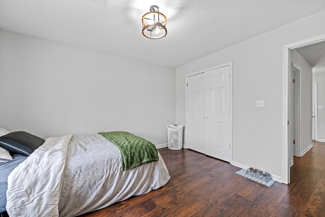 59 Crosswinds Cv, Henning, TN 38041 - bedroom featuring wood finished floors, a closet, baseboards, and a textured ceiling