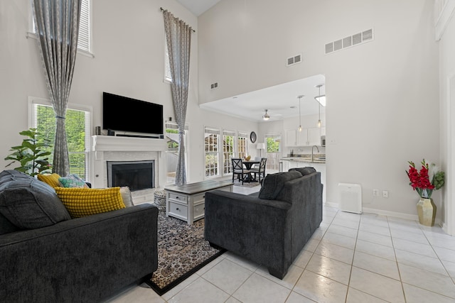 895 Joe Dr, Collierville, TN 38017 - living area featuring a high ceiling, a fireplace, light tile patterned flooring, and baseboards