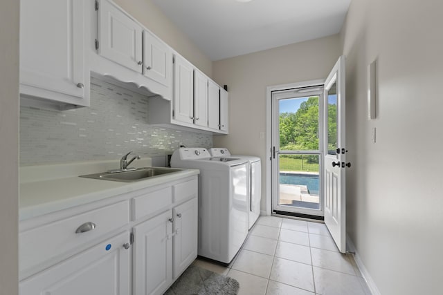 895 Joe Dr, Collierville, TN 38017 - laundry room with cabinet space, washer and clothes dryer, light tile patterned flooring, and baseboards