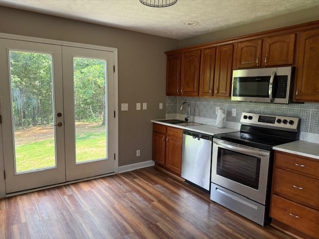 135 Lapa Ln, Clifton, TN 38425 - kitchen with stainless steel appliances, french doors, a sink, light countertops, and tasteful backsplash