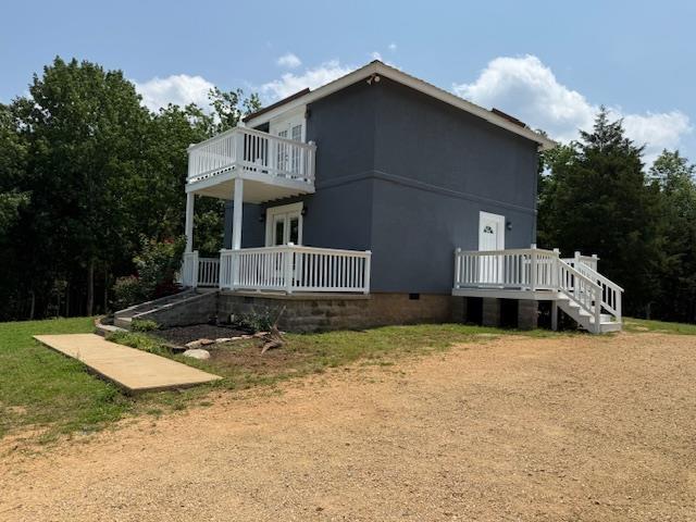 135 Lapa Ln, Clifton, TN 38425 - view of property exterior with crawl space and a balcony