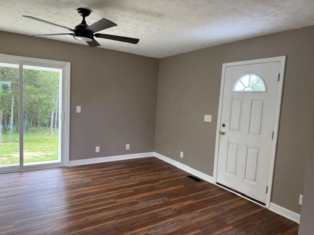 135 Lapa Ln, Clifton, TN 38425 - foyer with a textured ceiling, a ceiling fan, dark wood finished floors, and baseboards