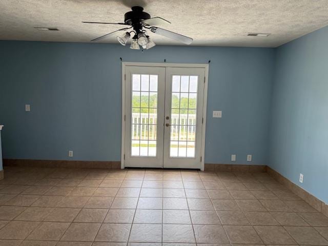135 Lapa Ln, Clifton, TN 38425 - unfurnished room with a textured ceiling, a ceiling fan, french doors, light tile patterned floors, and baseboards