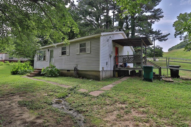 69 Crutcher Lake Rd, Henning, TN 38041 - view of side of home with a lawn, crawl space, and a wooden deck