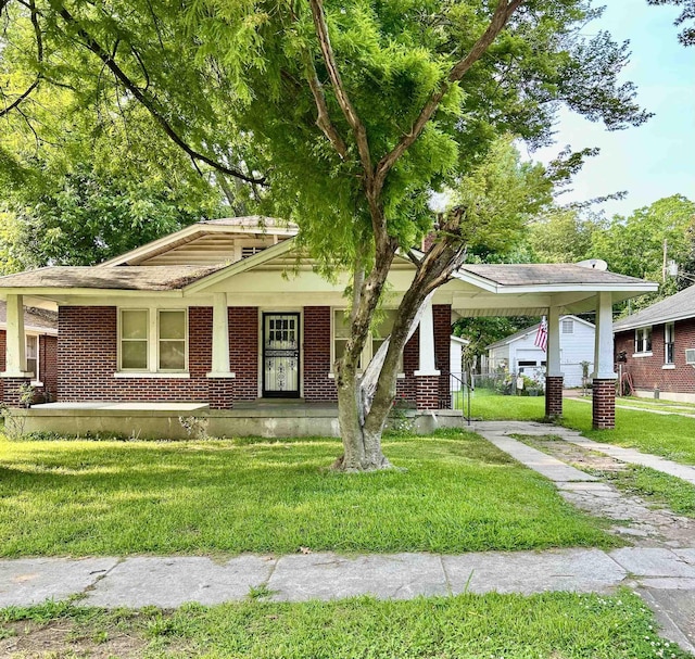 3224 Douglass Ave, Memphis, TN 38111 - view of front of home featuring a front yard, brick siding, and a carport