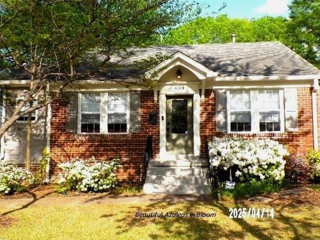 400 S Reese St, Memphis, TN 38111 - view of front facade with brick siding and a shingled roof