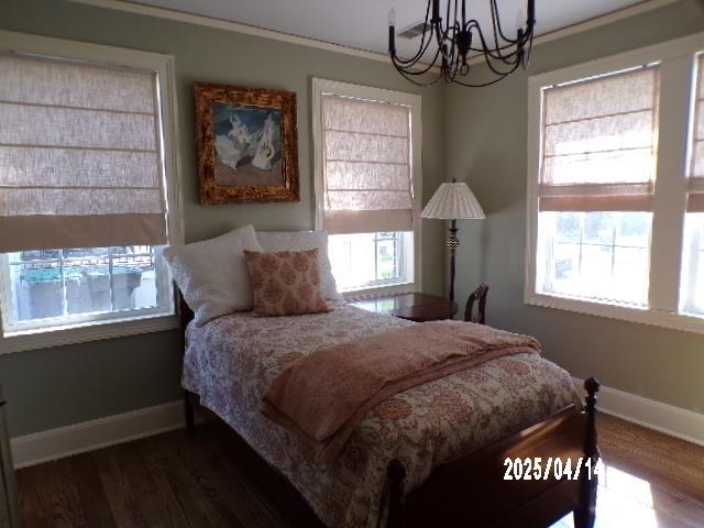 400 S Reese St, Memphis, TN 38111 - bedroom featuring a chandelier, baseboards, dark wood-type flooring, and crown molding