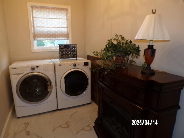 400 S Reese St, Memphis, TN 38111 - laundry room featuring washer and clothes dryer and light marble finish flooring