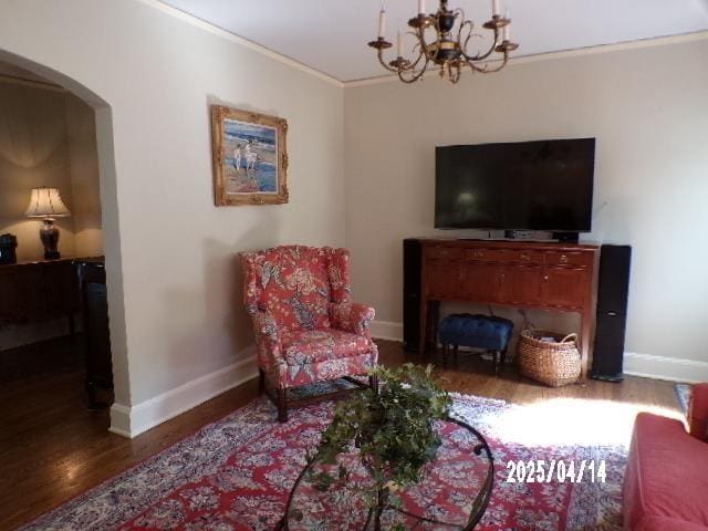 400 S Reese St, Memphis, TN 38111 - living area featuring wood finished floors, arched walkways, baseboards, a chandelier, and crown molding