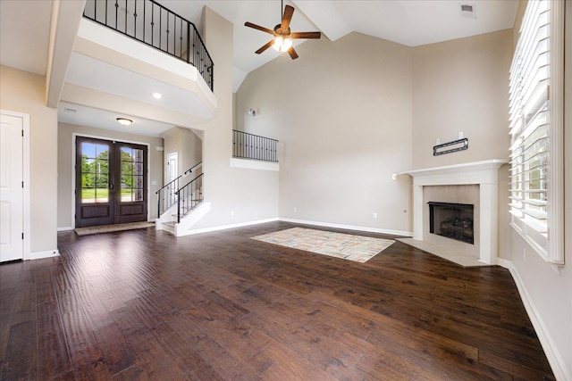 35 Laurel Pointe Cv, Oakland, TN 38060 - unfurnished living room with a ceiling fan, stairs, wood finished floors, a fireplace with flush hearth, and french doors