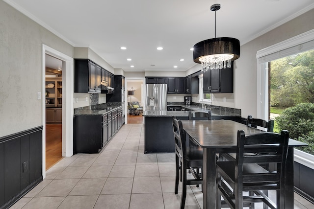 2019 Kostka Ln, Germantown, TN 38139 - kitchen featuring stainless steel refrigerator with ice dispenser, a chandelier, dark cabinets, crown molding, and dark stone counters