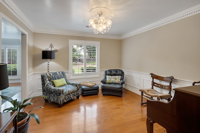 2019 Kostka Ln, Germantown, TN 38139 - sitting room featuring a chandelier, wood finished floors, crown molding, wainscoting, and a decorative wall