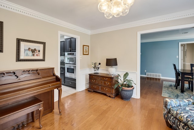 2019 Kostka Ln, Germantown, TN 38139 - sitting room with a chandelier, light wood finished floors, crown molding, and wainscoting