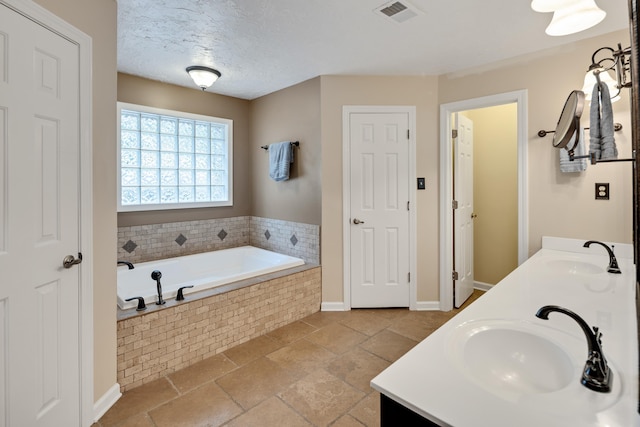 2019 Kostka Ln, Germantown, TN 38139 - bathroom featuring double vanity, a bath, and baseboards