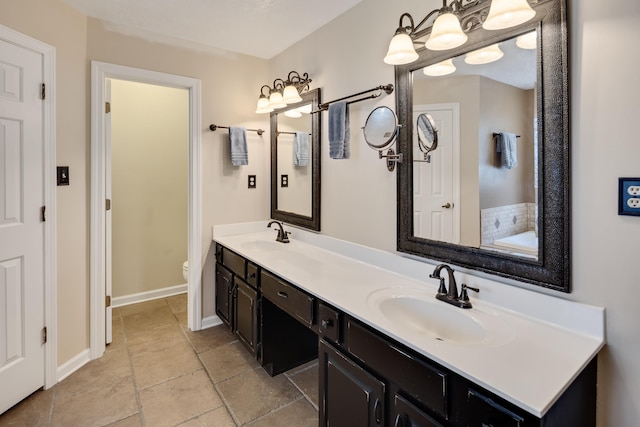 2019 Kostka Ln, Germantown, TN 38139 - full bath with double vanity, toilet, baseboards, and stone finish flooring