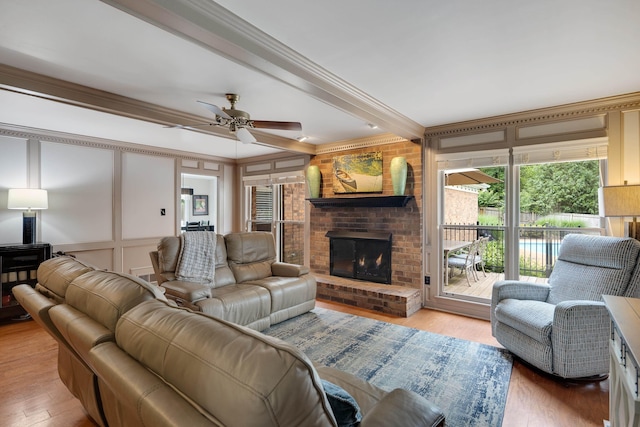 2019 Kostka Ln, Germantown, TN 38139 - living room featuring a decorative wall, a fireplace, crown molding, wood finished floors, and ceiling fan