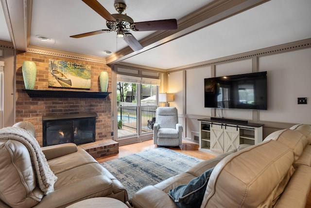 2019 Kostka Ln, Germantown, TN 38139 - living area with a decorative wall, a fireplace, a ceiling fan, crown molding, and wood finished floors