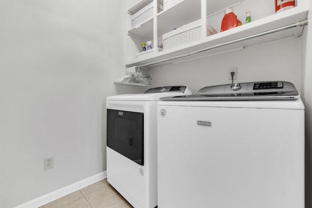 7255 Barnstable Dr, Memphis, TN 38125 - laundry area with washing machine and dryer, light tile patterned floors, and baseboards