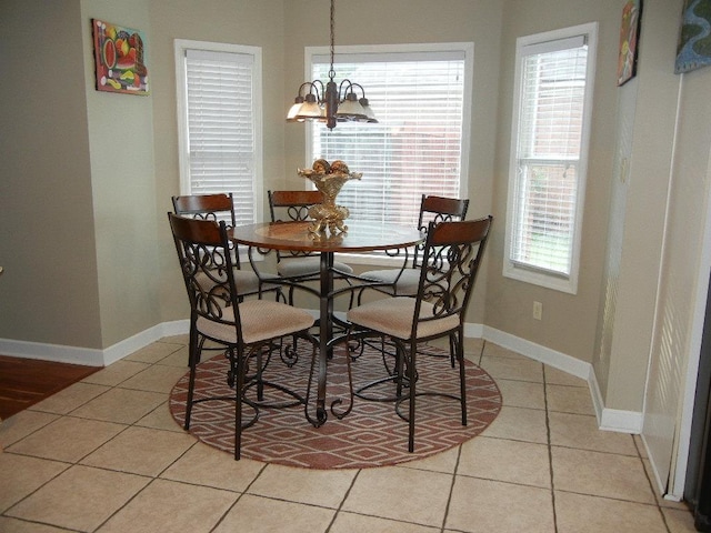 197 Walnut Gardens Dr, Memphis, TN 38018 - dining room with light tile patterned floors, a chandelier, and baseboards