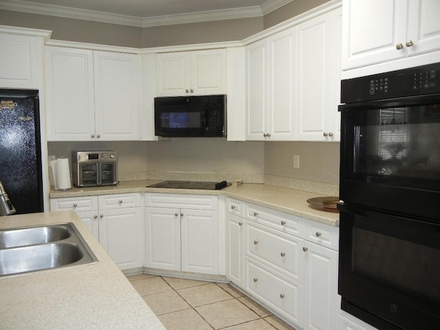197 Walnut Gardens Dr, Memphis, TN 38018 - kitchen with black appliances, a sink, crown molding, white cabinets, and light countertops