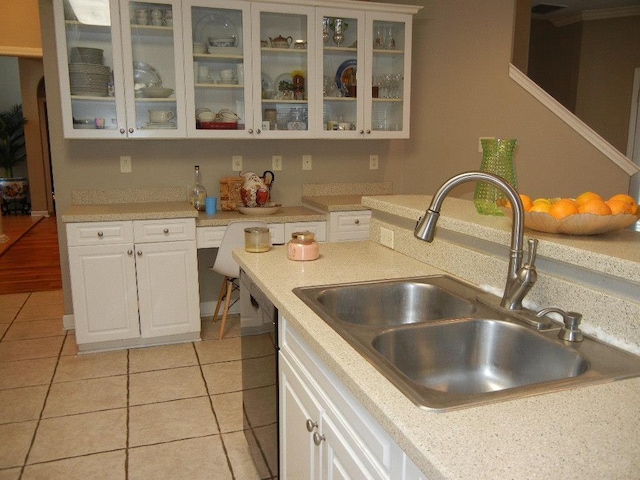 197 Walnut Gardens Dr, Memphis, TN 38018 - kitchen featuring a sink, white cabinetry, light tile patterned floors, and black dishwasher
