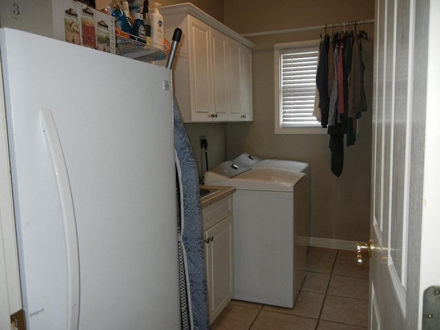 197 Walnut Gardens Dr, Memphis, TN 38018 - laundry area featuring independent washer and dryer, cabinet space, light tile patterned floors, and baseboards